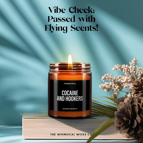 Amber glass jar candle with a pink label that reads βCocaine and Hookersβ in bold text, lit and placed on a smooth stone with dried lavender nearby, styled against a soft aqua background. Playful, edgy, and perfect for adult humor gifts or novelty candle lovers.