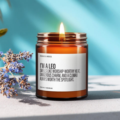 Amber glass jar candle labeled “I’m a Leo – Smells like worship-worthy heat, dangerous charm, and a climax always worth the spotlight” on a softly lit table.