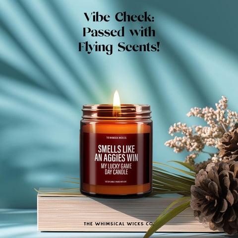 A flat lay image of the “Smells Like An Aggies Win” candle surrounded by dried lavender and soft textures. The warm maroon label pops, combining game day energy with a calm, cozy home vibe. Great for Texas A&M fans who love mixing fierce football spirit with comforting candle-lit moments.