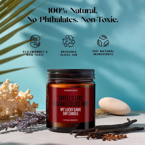 Branded graphic highlighting sustainable elements: 100% soy wax, lead-free wick, recyclable amber jar, and non-toxic fragrance. The candle labeled “Smells Like A Gamecocks Win” is centered, appealing to eco-conscious fans who love their team and value clean, mindful living. Designed for guilt-free celebration during game season.