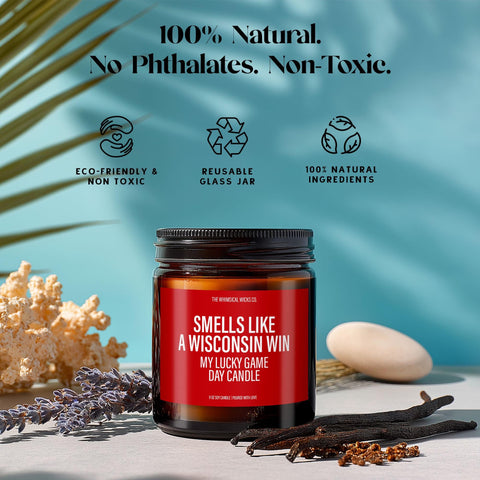Eco-friendly soy candle labeled “Smells Like A Wisconsin Win – My Lucky Game Day Candle.” Surrounded by lavender, vanilla beans, coral, and icons highlighting its reusable glass jar, natural ingredients, and non-toxic formula. A sustainable football gift for game day fans and Wisconsin loyalists.
