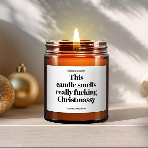 Hero image – 9oz amber glass jar candle
Close-up of a 9oz amber glass jar candle with black metal lid, white label reading “This Candle Smells Really Fucking Really Christmassy” in bold black text, styled on a neutral background with warm lighting, perfect for humorous and offensive Christmas gifting.