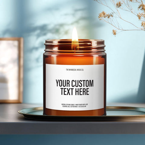 Close-up of a 9oz amber glass jar candle with black metal lid, white label reading “Your Words Here” in bold black text, styled on a neutral background with warm lighting, perfect for showcasing custom personalized candles.